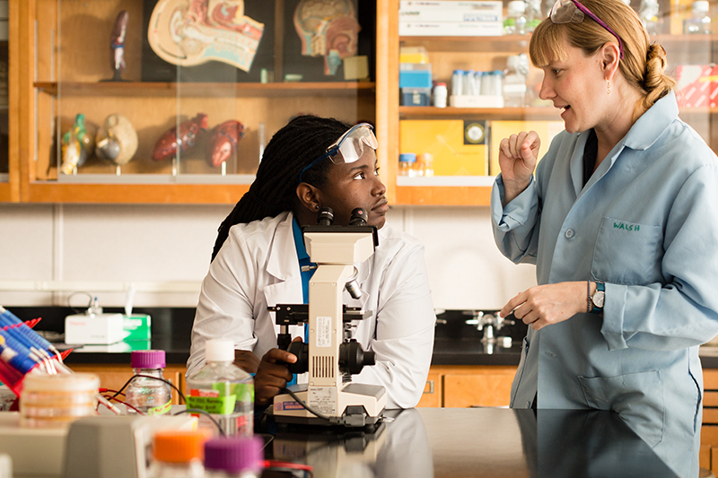 Professor and student working in a biology lab.