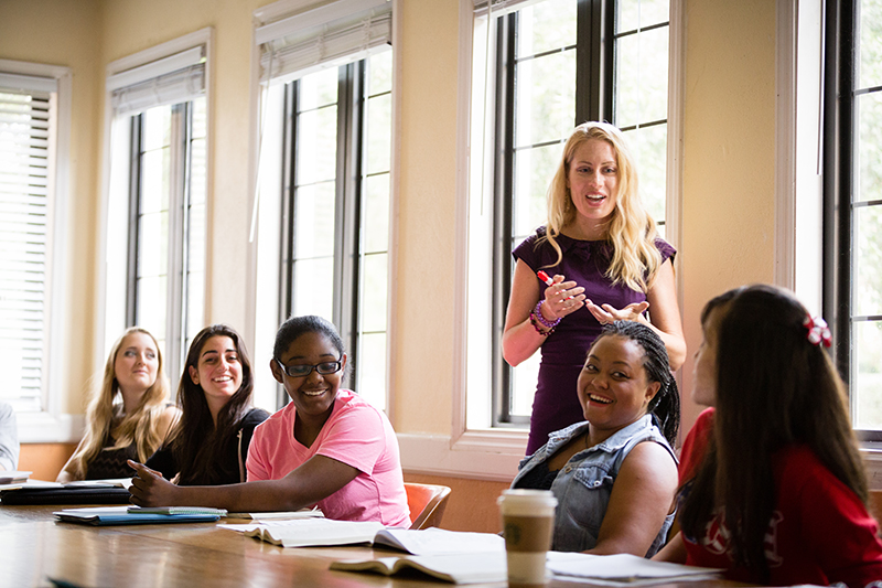 A Rollins English professor engages a group of students in class discussion.